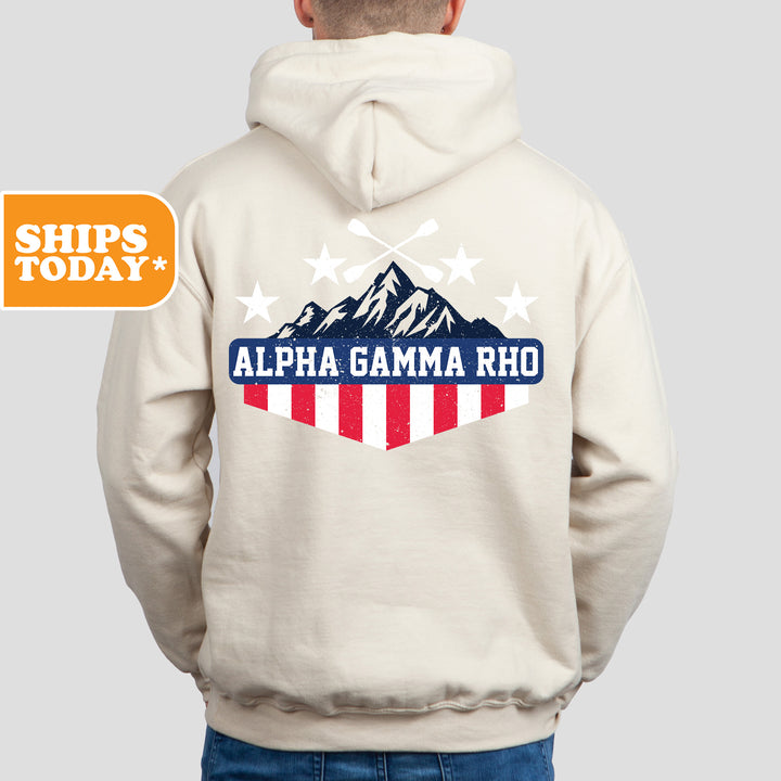 a man wearing a white hoodie with an american flag on it