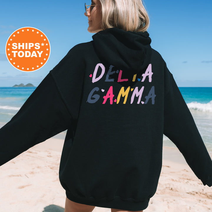 a woman wearing a black hoodie with the words delta gama printed on it