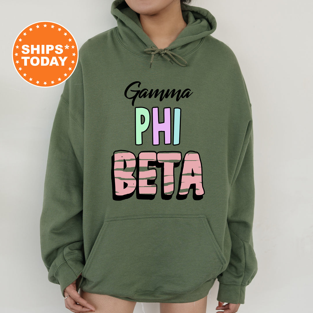 a woman wearing a green hoodie with the words gaumaa phi beta