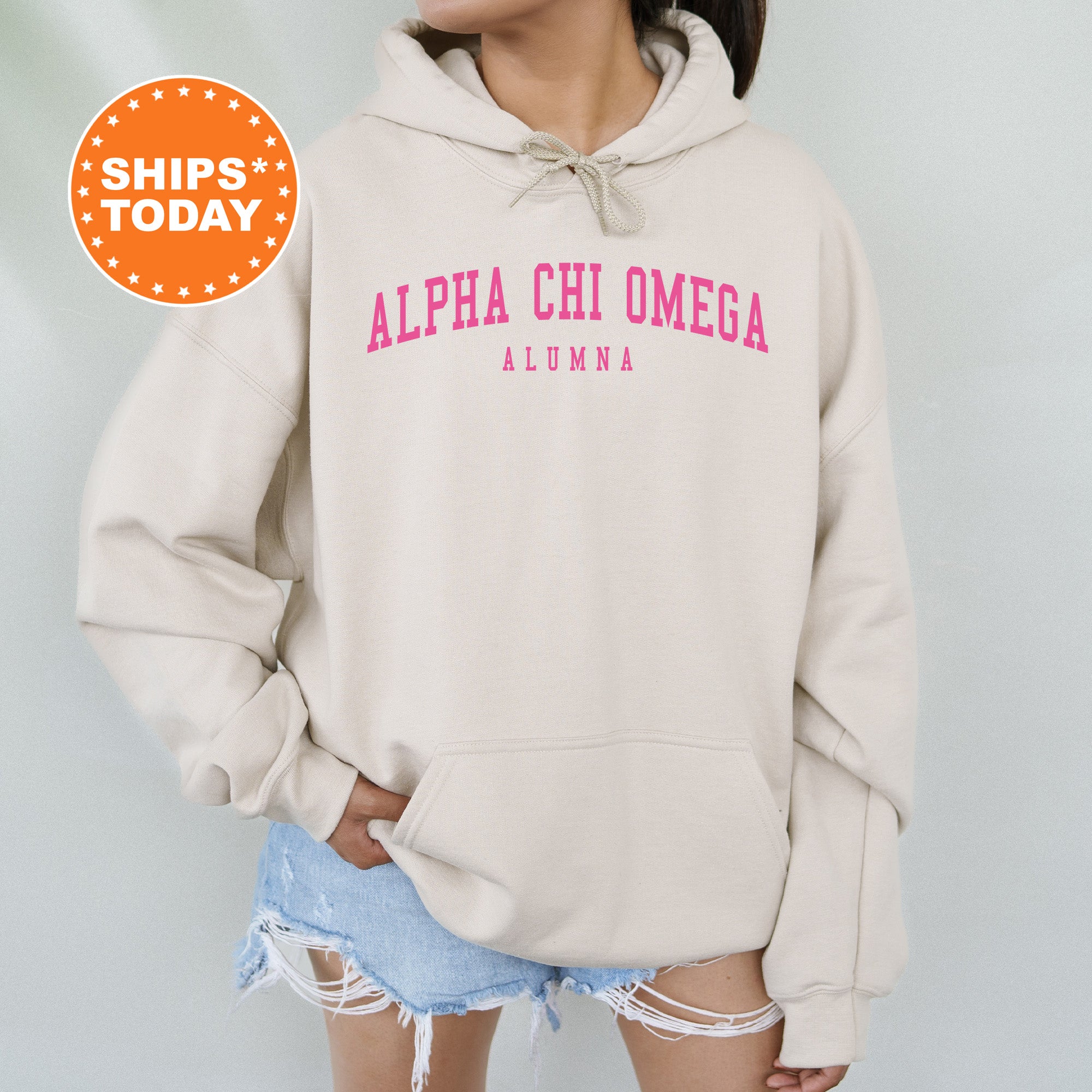 a woman wearing a hoodie with the words alpa chi omega on it