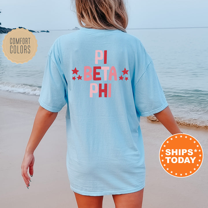 a woman walking on the beach in a blue shirt