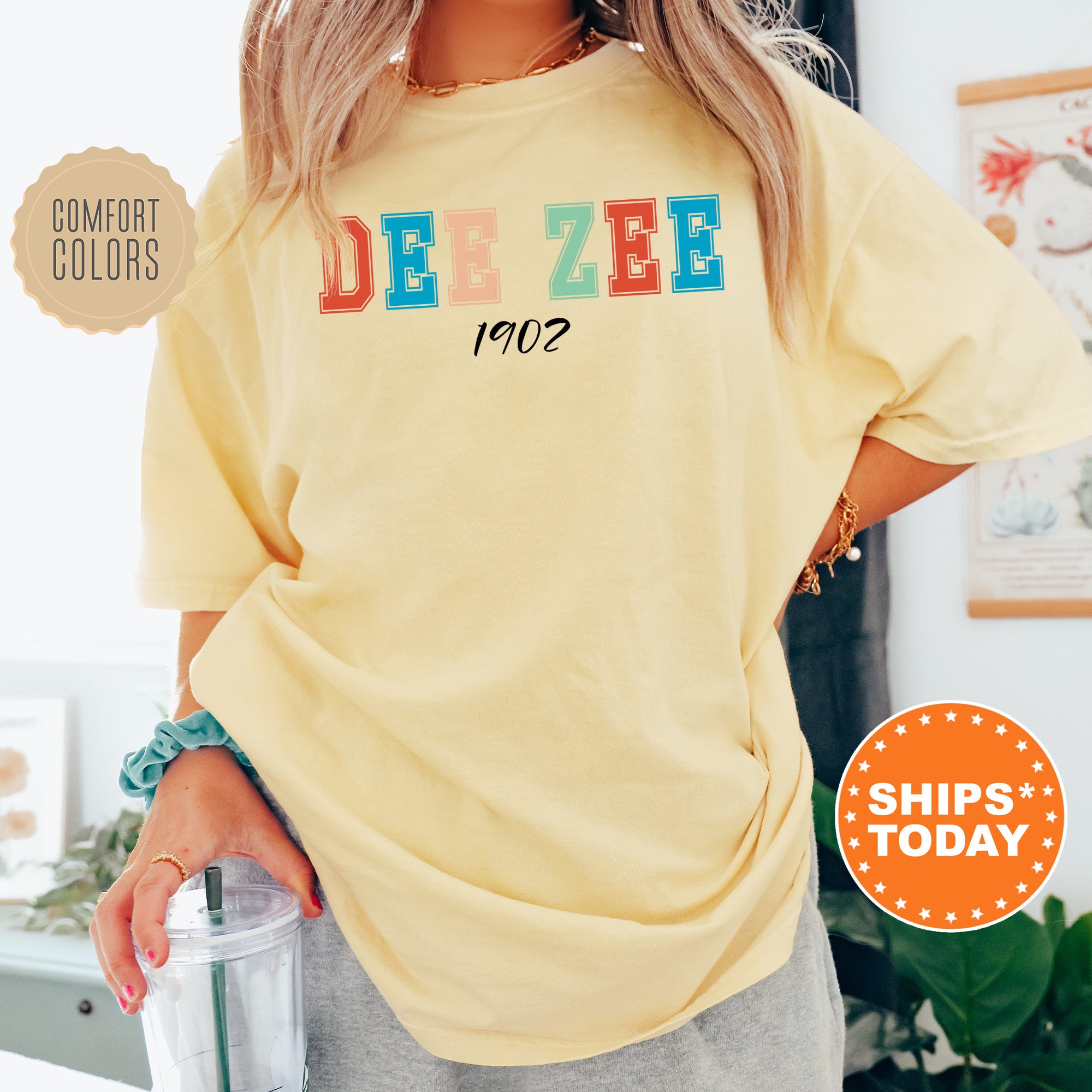 a woman in a yellow shirt holding a blender
