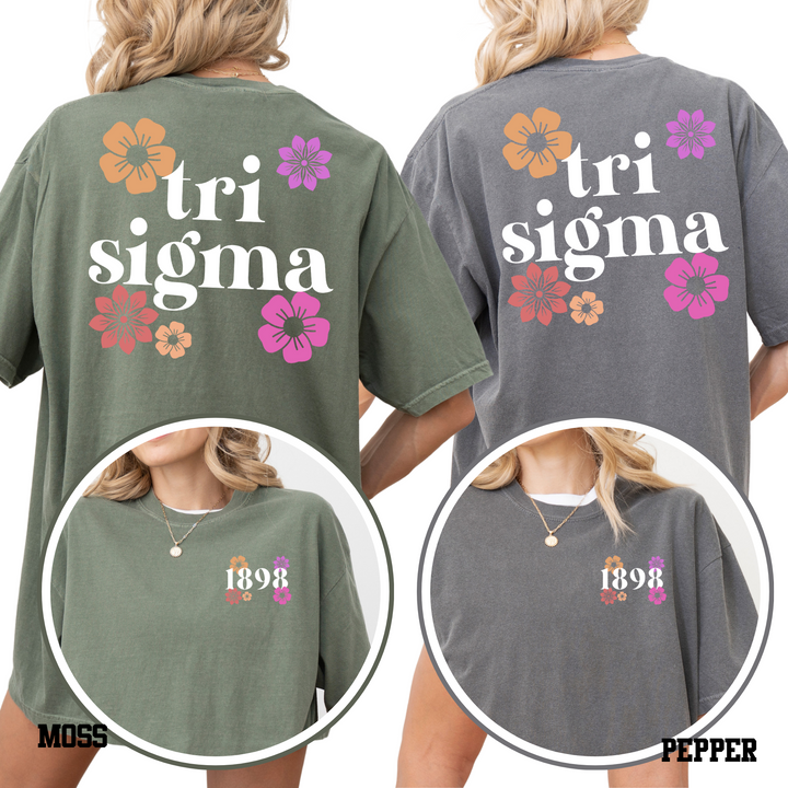 two back views of women wearing green t-shirts with the text "tri sigma" printed on them.