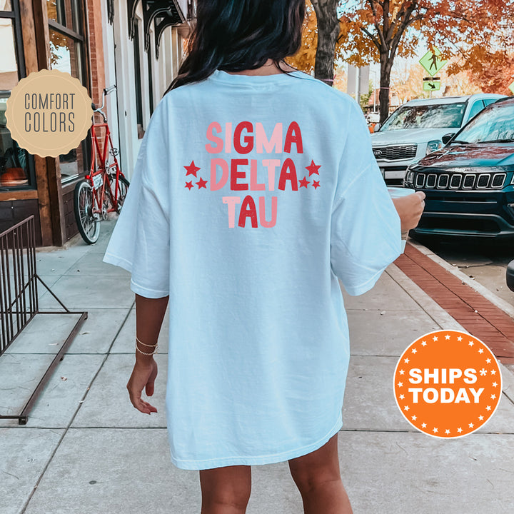 a woman walking down a sidewalk wearing a t - shirt