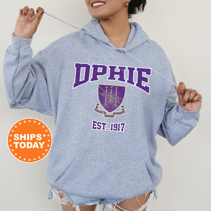 a woman in a blue hoodie holding a toothbrush