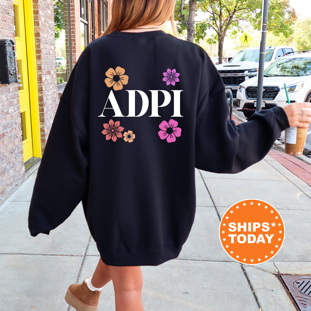 a woman walking down a sidewalk wearing a black sweatshirt
