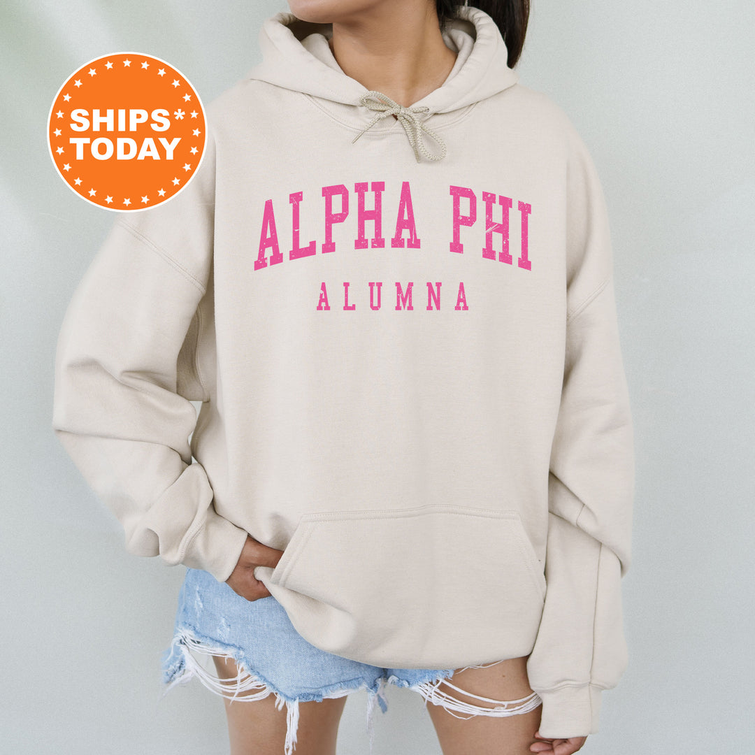 a woman wearing a sweatshirt with the word alpha phi on it