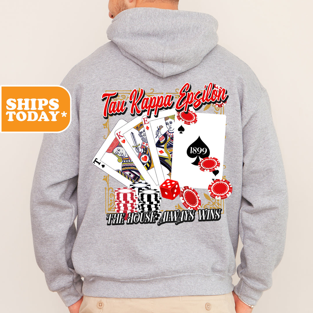 a man wearing a gray hoodie with a picture of playing cards on it
