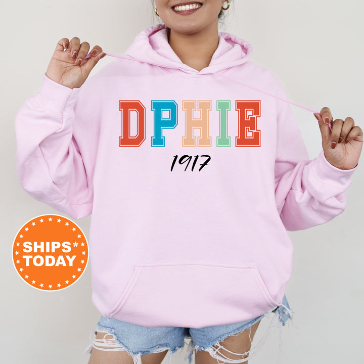 a woman wearing a pink hoodie with the word dppie printed on it