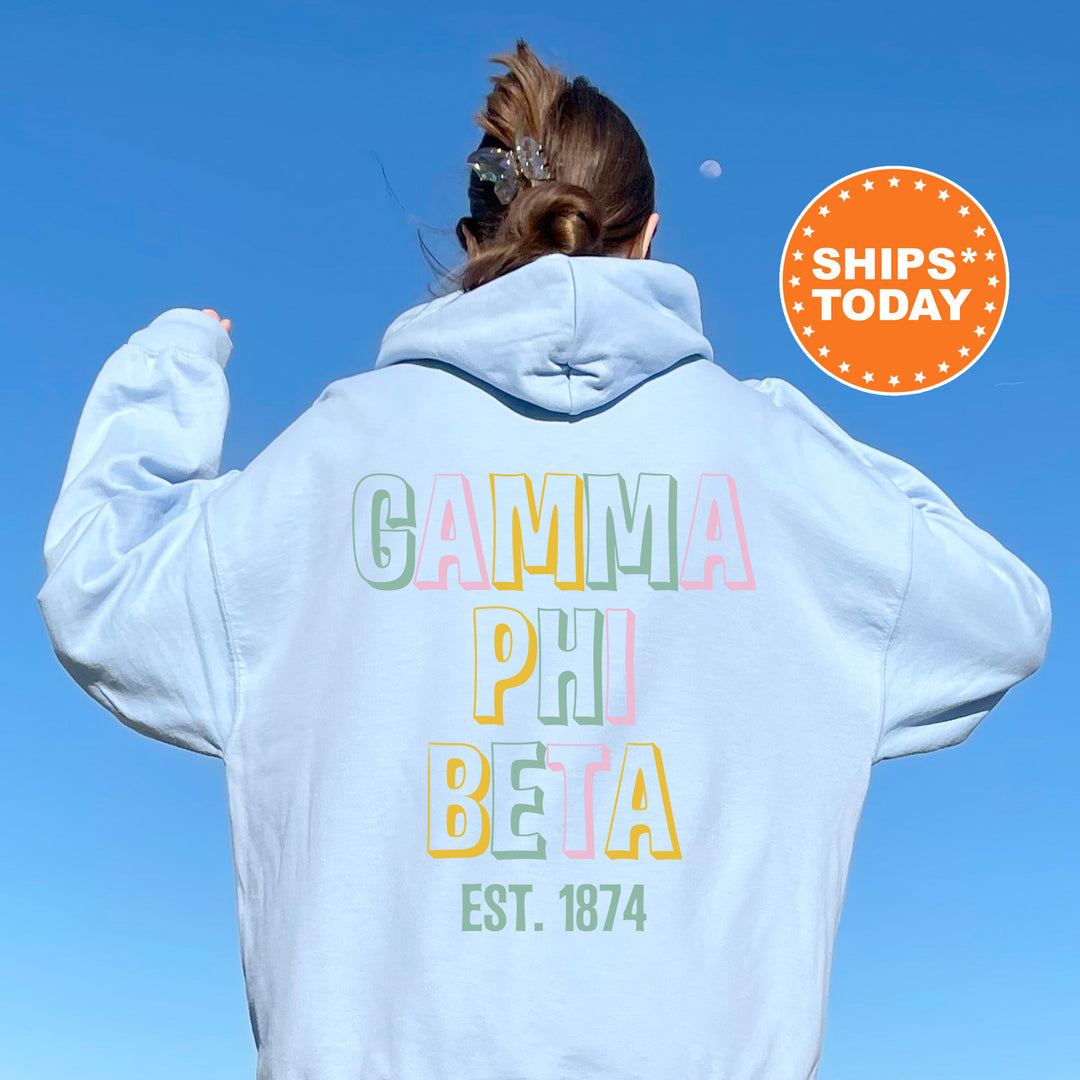 a woman wearing a white hoodie with the words gama phi beha on