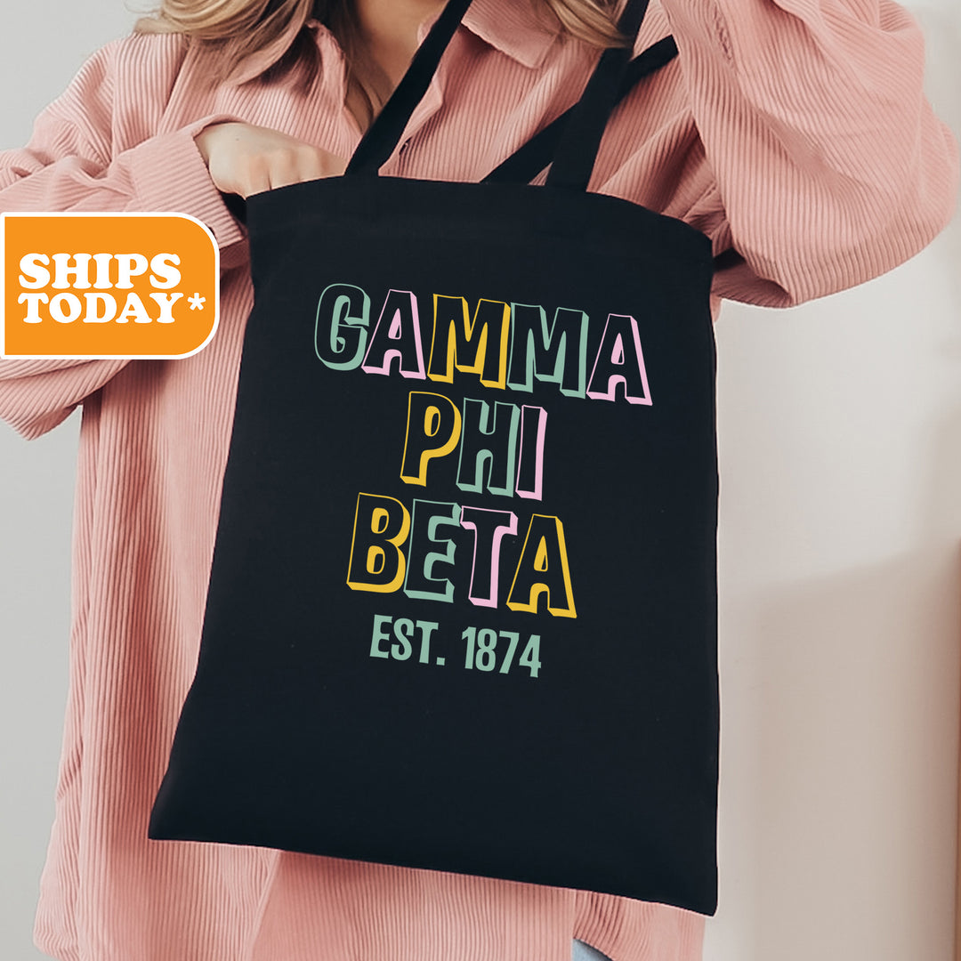 a woman is holding a black bag with the words gamma phi beta est
