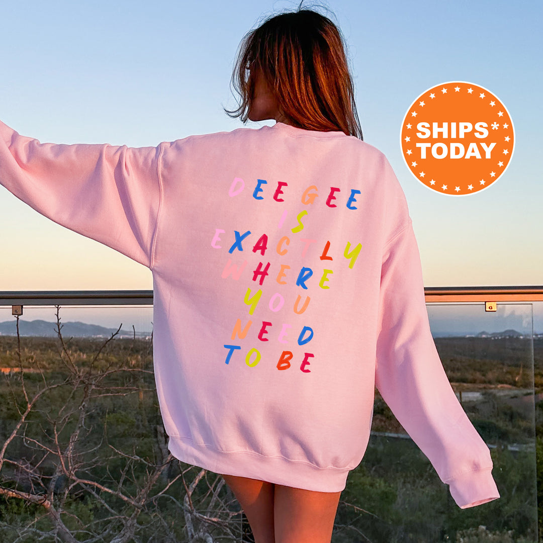 a woman wearing a pink sweatshirt with words written on it
