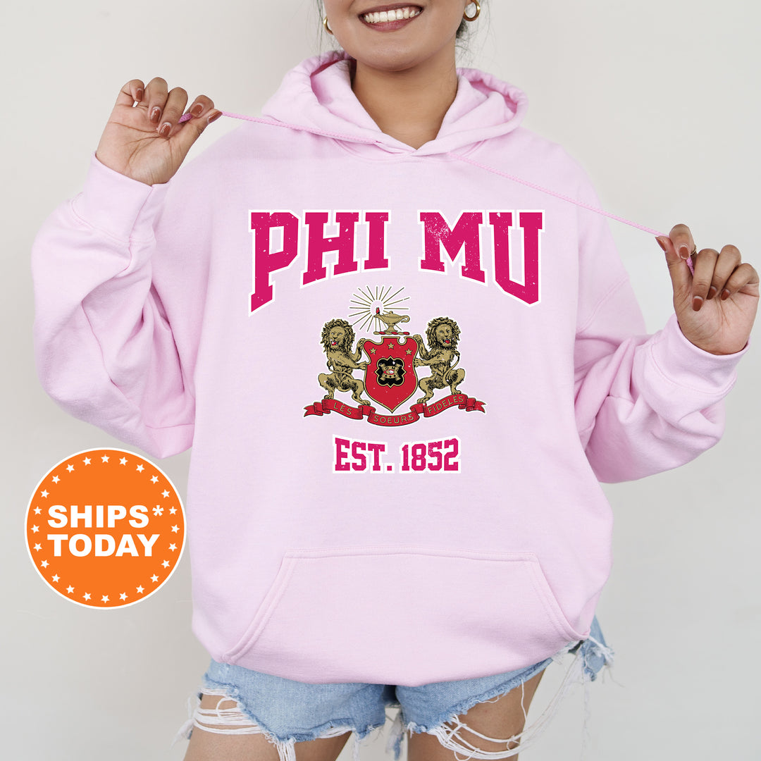 a woman wearing a pink phi mu hoodie