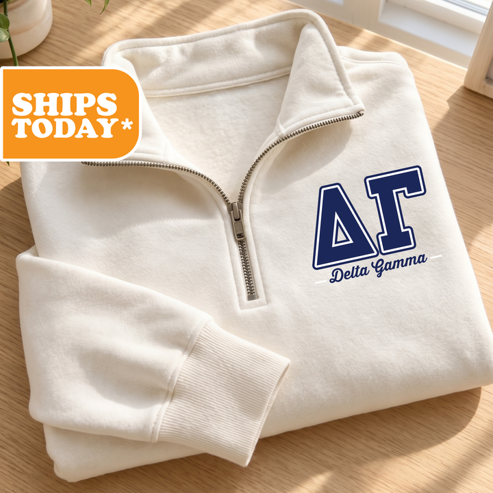A white zip-up jacket with a blue "ΑΓΙΚΗ" logo on the left chest area, placed on a wooden surface.