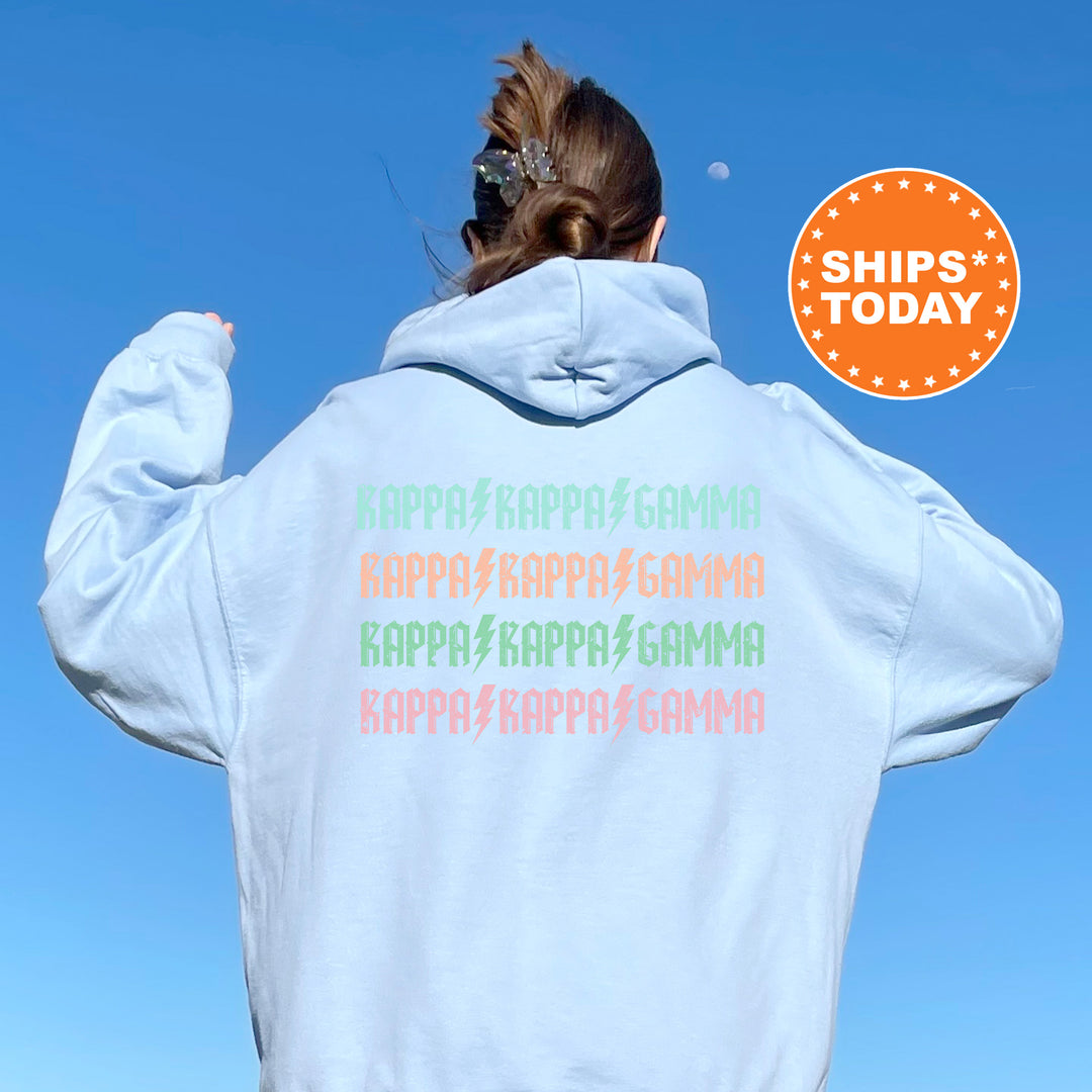 a woman wearing a white hoodie with rainbow writing on it