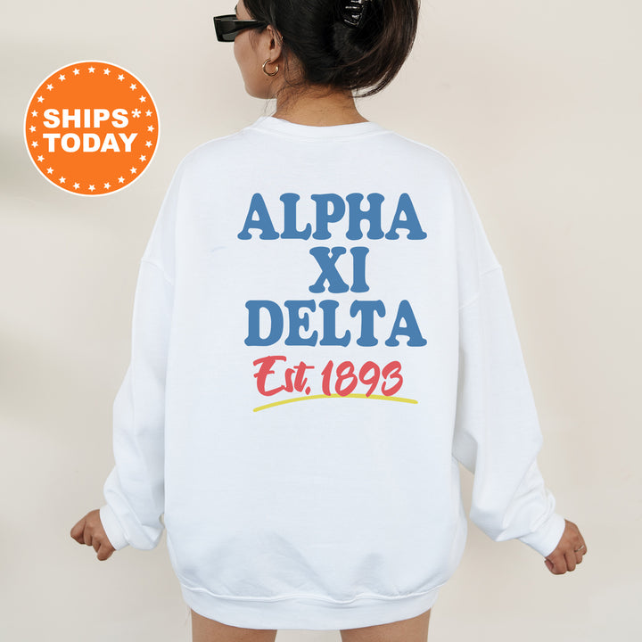 A person wearing a white sweatshirt with text and logos printed on the back.