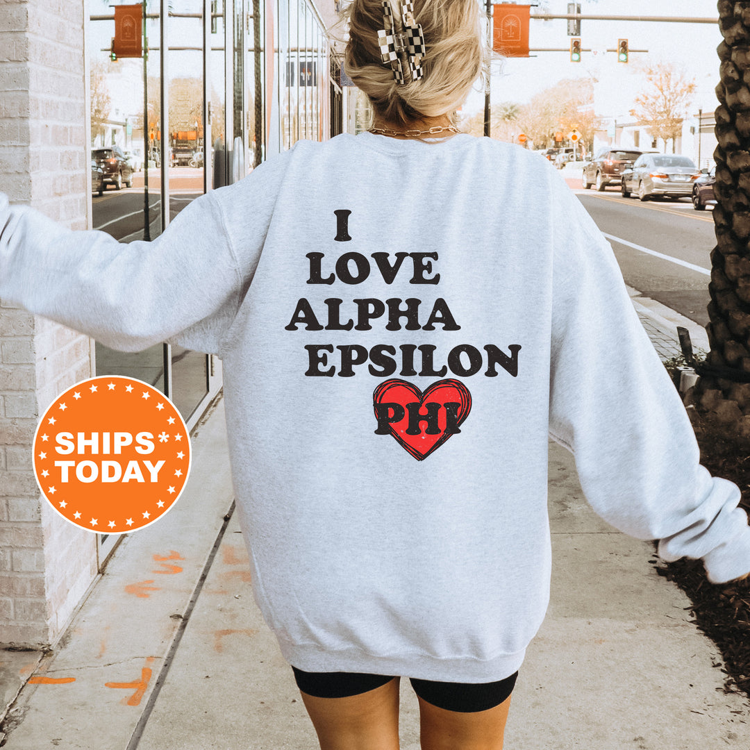a woman walking down a sidewalk wearing a sweatshirt
