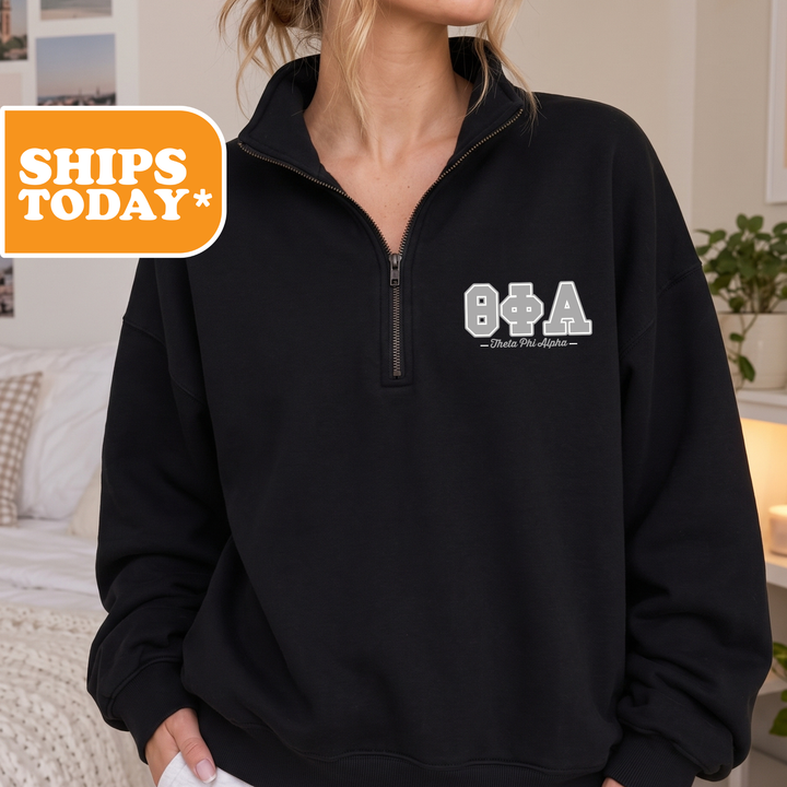 A person wearing a black sweatshirt with the text "B&A" printed on it.