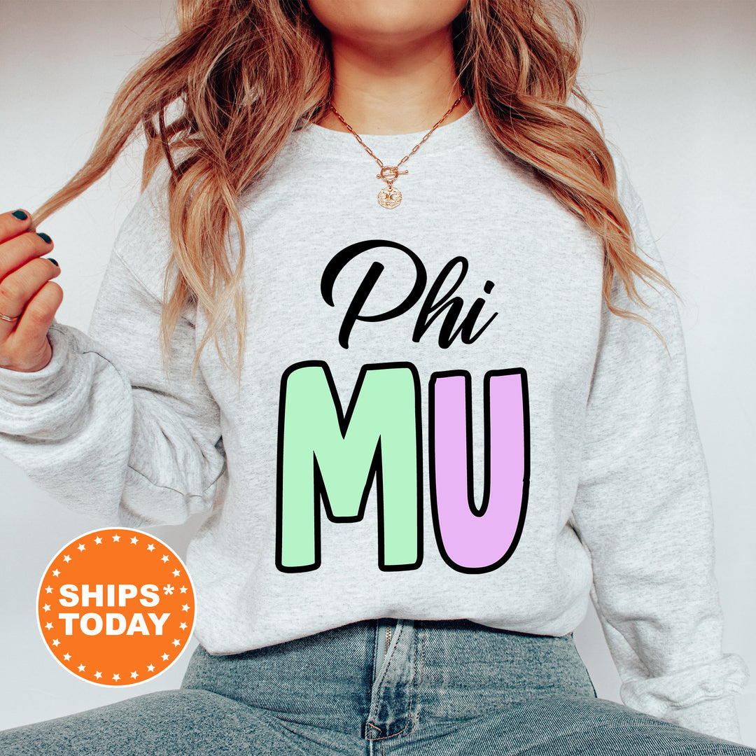 a woman wearing a sweatshirt that says phi mu