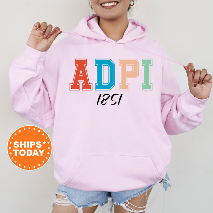 a woman wearing a pink hoodie with the word adpi printed on it