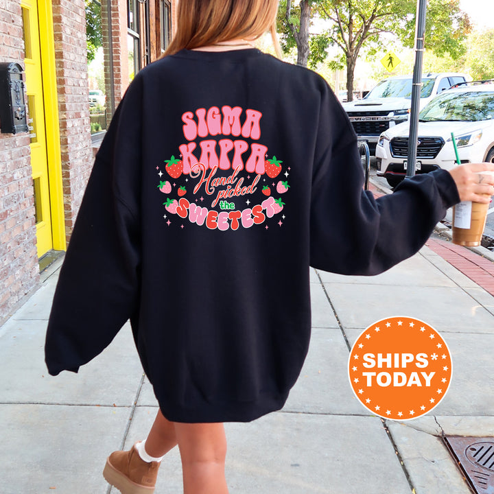 a woman walking down a sidewalk wearing a sweatshirt