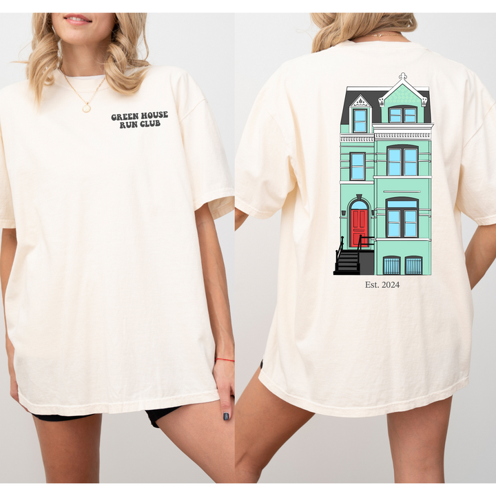 a woman wearing a t - shirt with a picture of a house on it