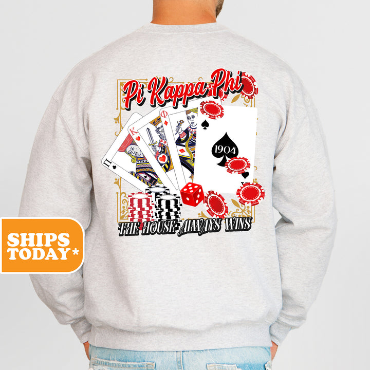 a man wearing a sweatshirt that has a picture of playing cards on it