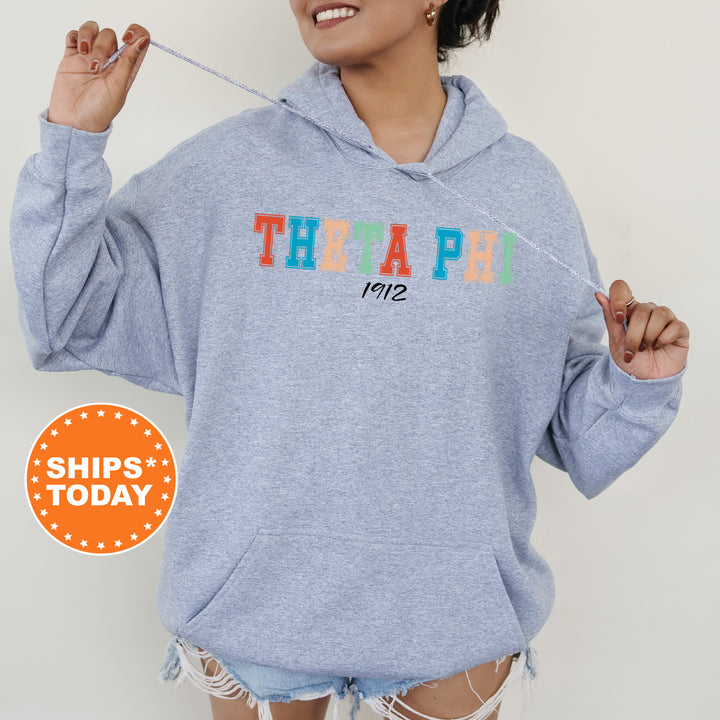 a woman wearing a blue hoodie with the words therapy on it
