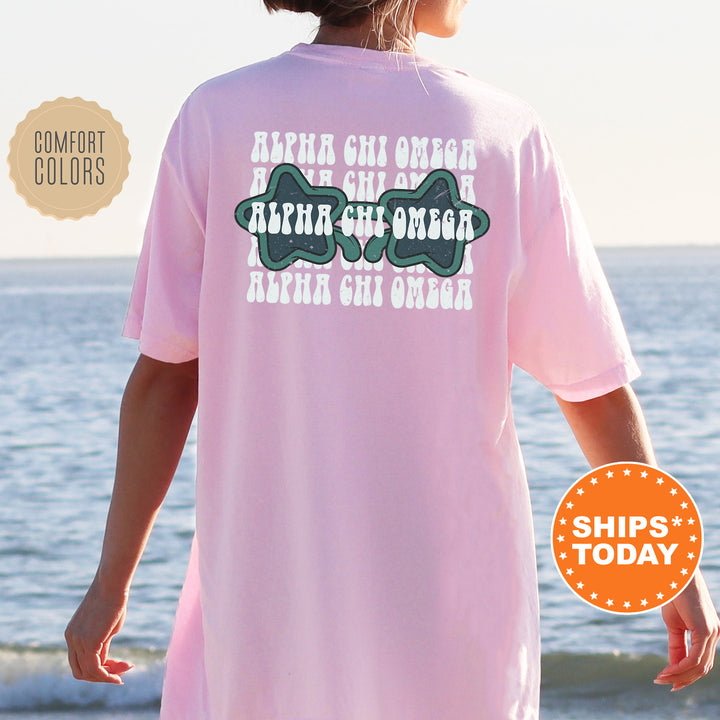 a woman in a pink shirt is standing on the beach