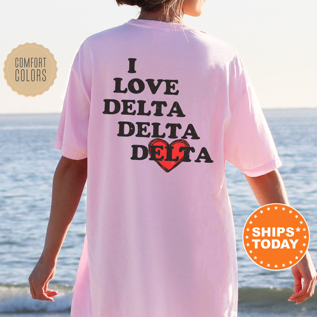 a woman wearing a pink shirt that says i love delta delta