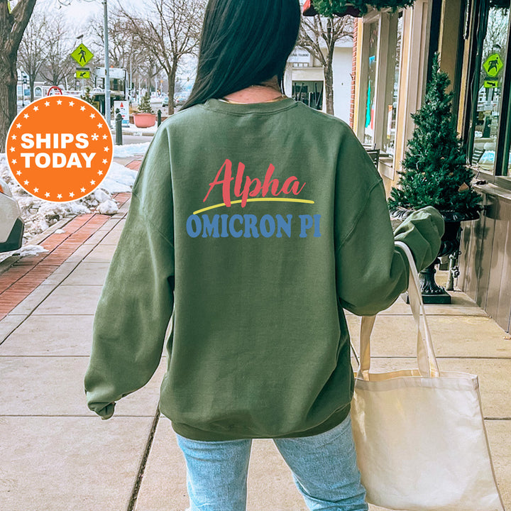 A person wearing a green sweatshirt with the text "Alpha Omega Pi" printed on it, walking on a sidewalk.