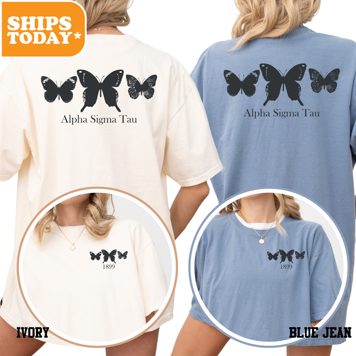 a woman wearing a blue and white shirt with black butterflies on it
