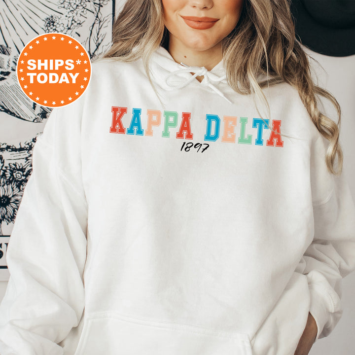 a woman wearing a white kapa delta hoodie