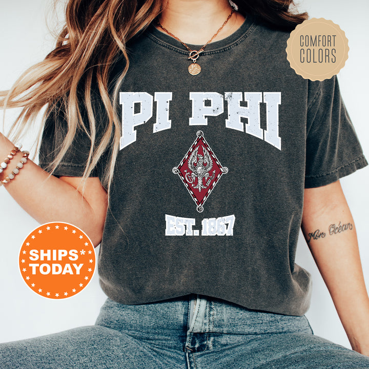 a woman wearing a phi phi shirt and jeans
