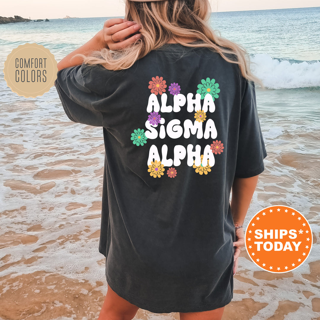 a woman standing on a beach wearing a black shirt