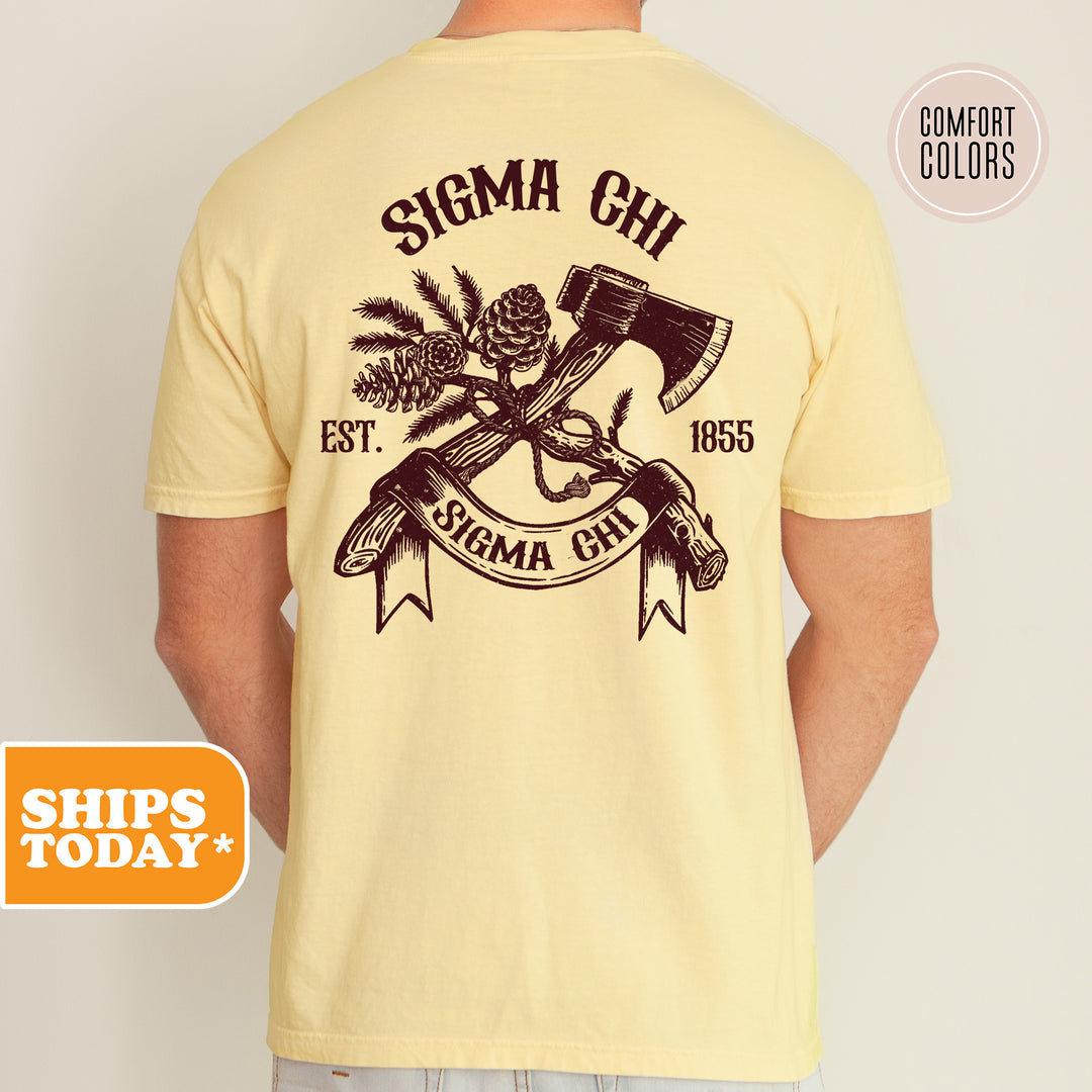 a man wearing a yellow shirt with an image of a hammer and a pine tree