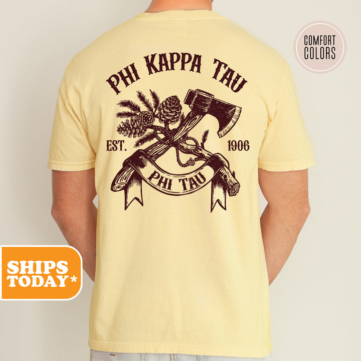 a man wearing a yellow phi kapa t - shirt with a hammer and pine