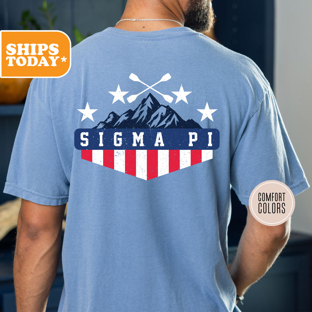 a man wearing a blue shirt with a picture of a mountain