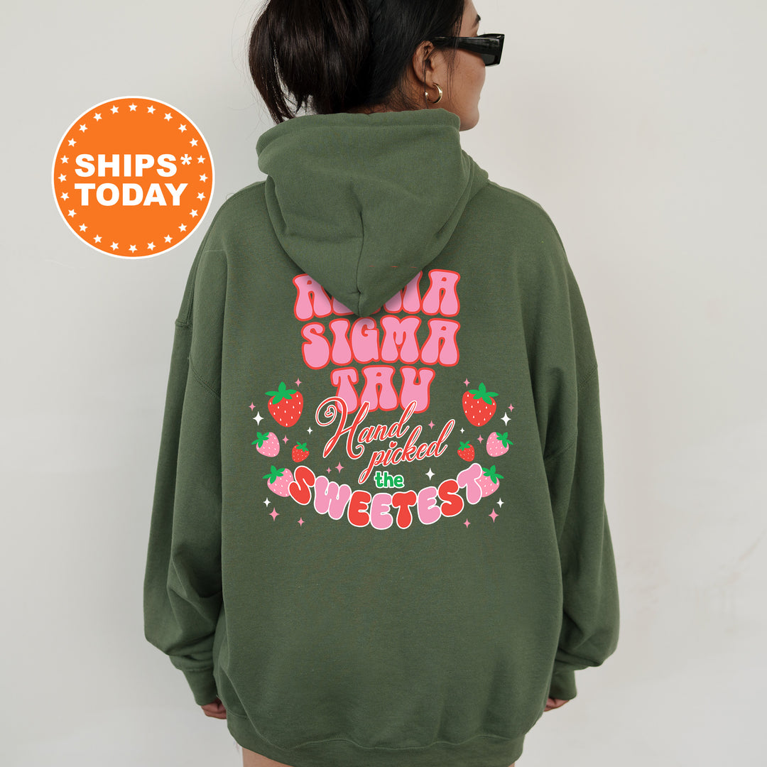 a woman wearing a green hoodie with a pink bow on it