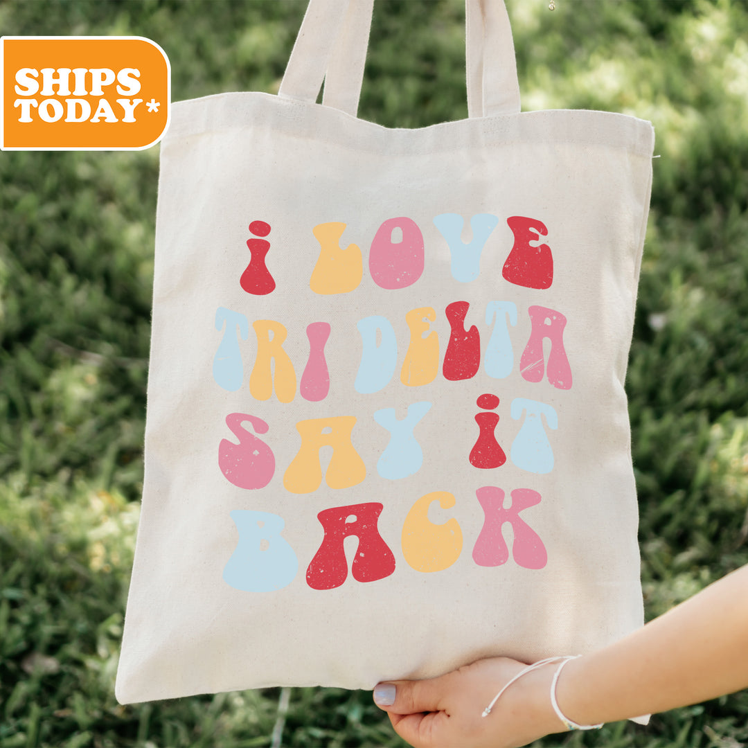 a person holding a tote bag with the words love rider say back on it