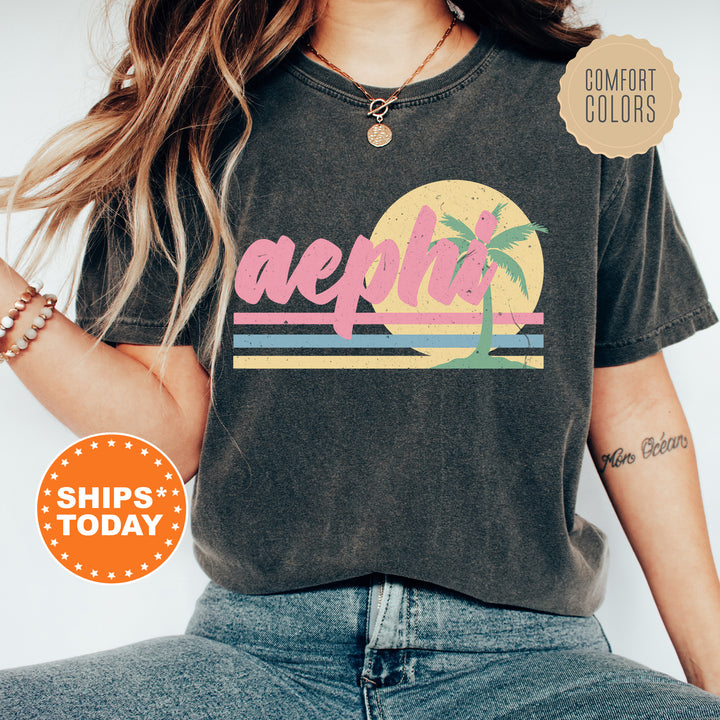 a woman wearing a t - shirt with a palm tree on it