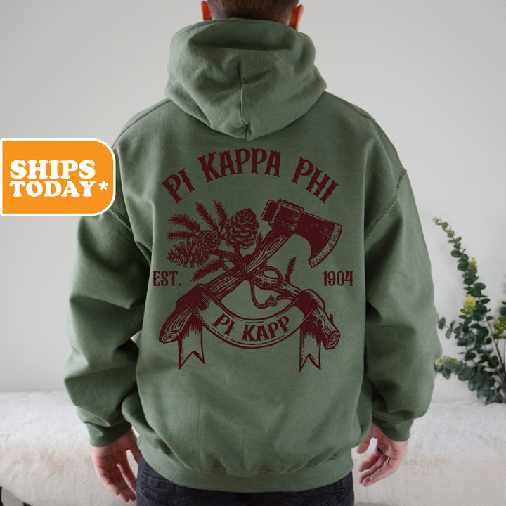 a man wearing a green hoodie with a hammer and crossed axes on it