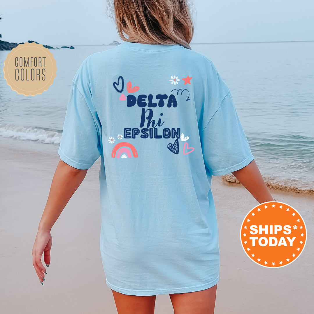 a woman walking on the beach in a blue shirt