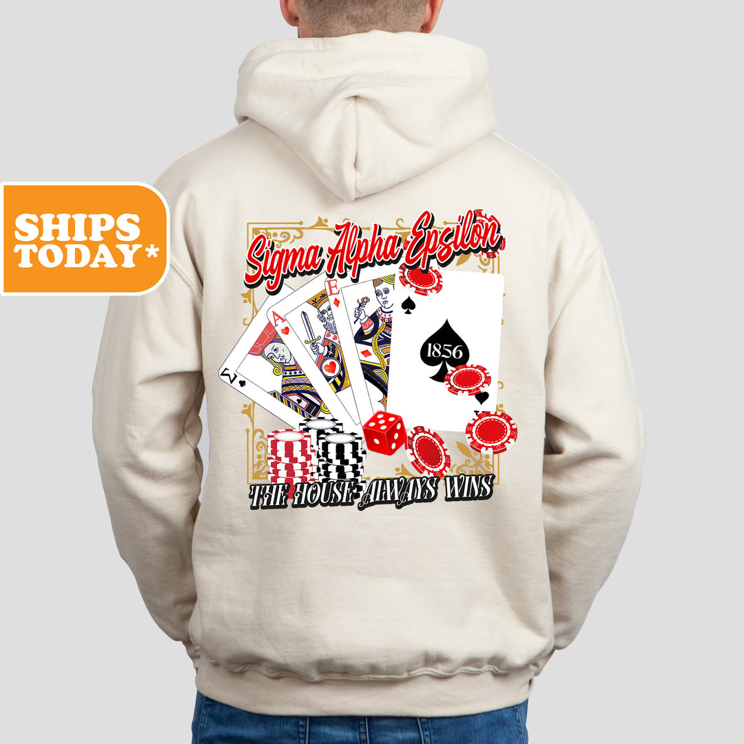a man wearing a white hoodie with a picture of playing cards on it