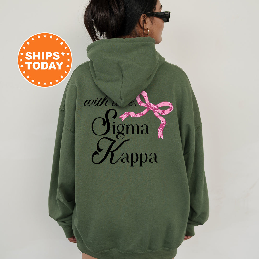 a woman wearing a green hoodie with a pink ribbon