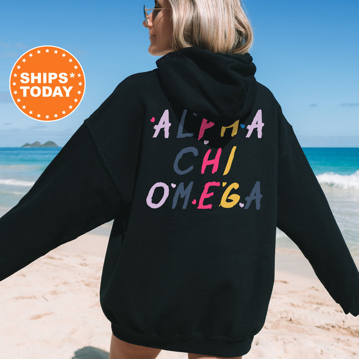 a woman in a black hoodie on the beach