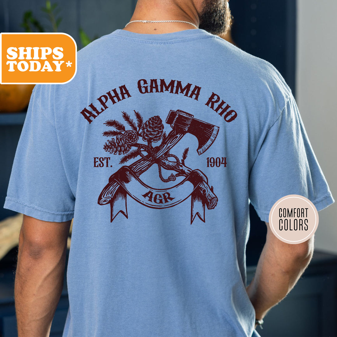 a man wearing a blue shirt with a hammer and pine cones on it