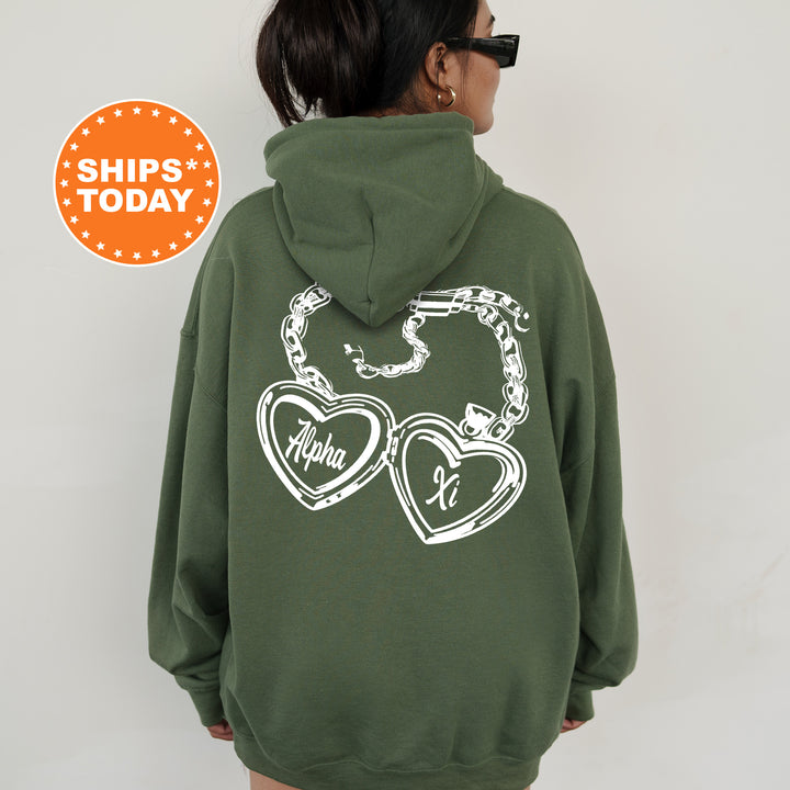 A person wearing a green hoodie with a graphic design on the back.