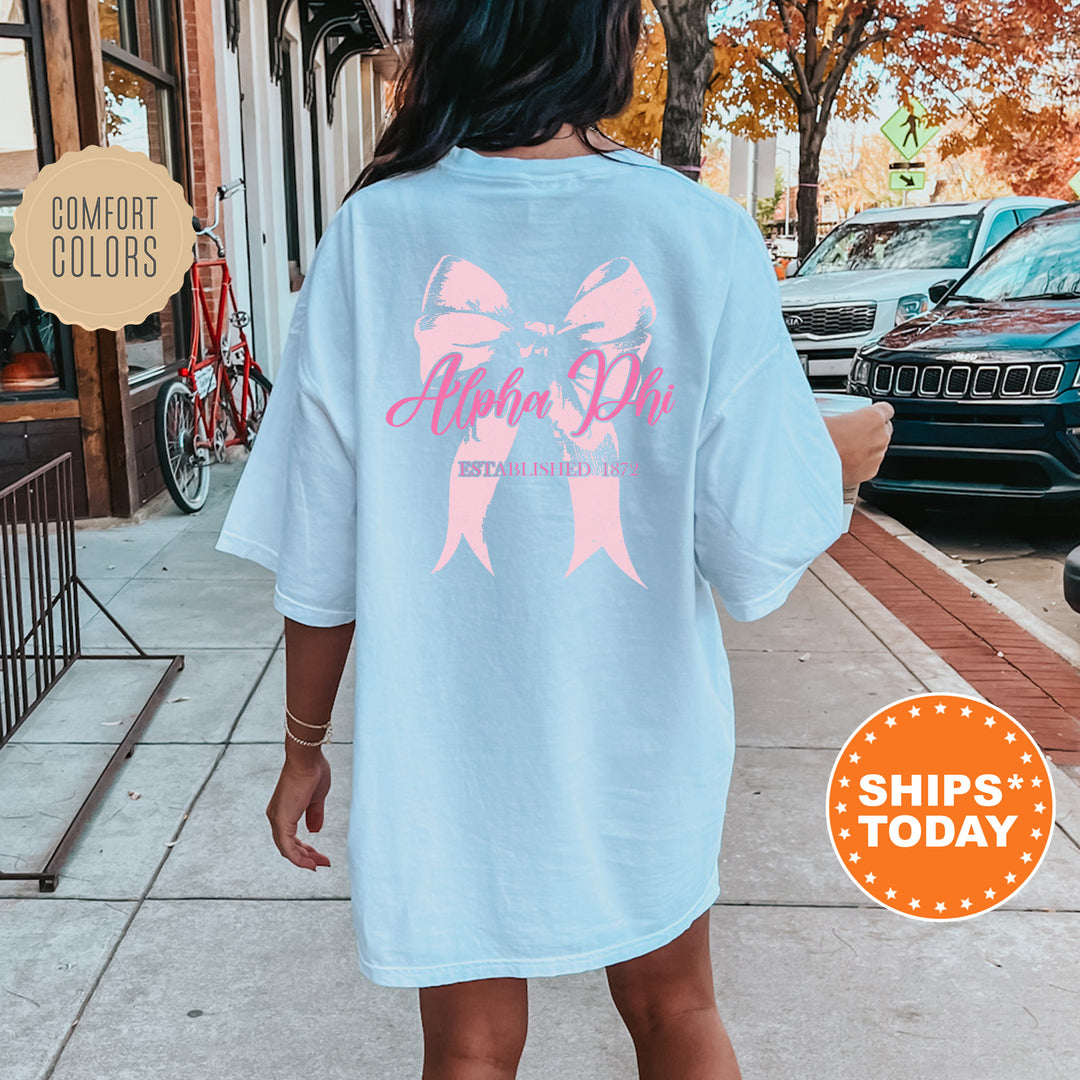 a woman is walking down the sidewalk with a pink ribbon on her shirt