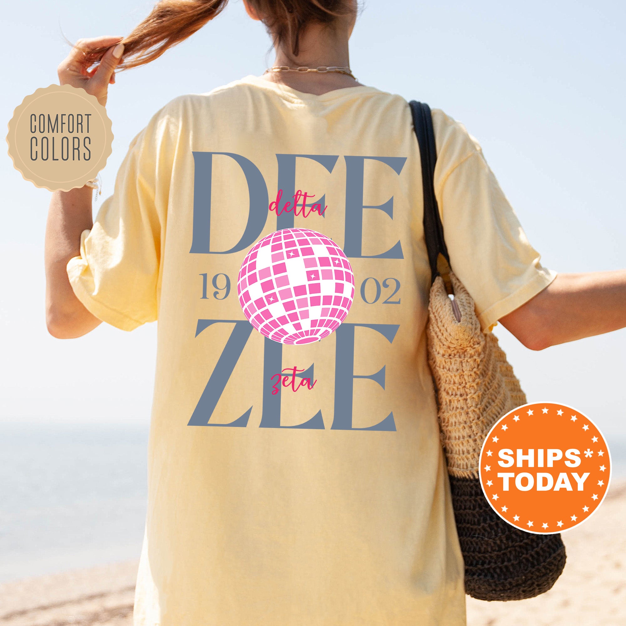 a woman walking on the beach with a t - shirt that says dee zeee